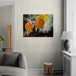 Bold and dark abstract landscape with orange, gold, blue and blackposter format displayed in a living space with grey wall and grey furniture