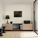 Energetic abstract landscape with black, gold and dark greenposter format displayed in a modern living room, wooden tv furniture