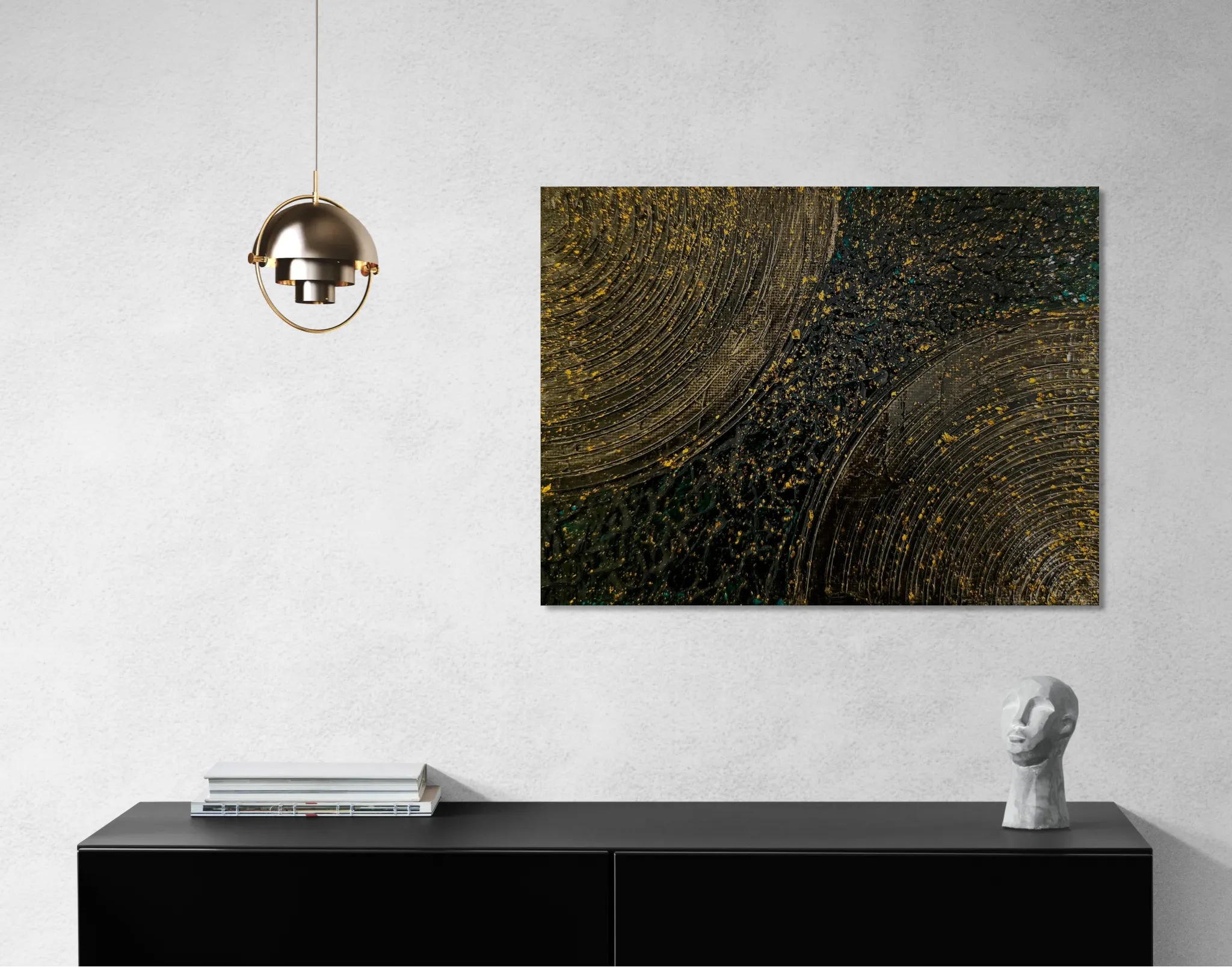 Energetic abstract landscape with black, gold and dark greenposter format displayed in a grey wall, black desk