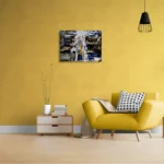Fluid and dark abstract landscape with black, white, gold and blueposter format displayed in a living room, yellow wall