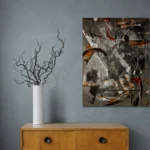 Geometrical, bold and dark abstract portrait in black, grey, white, brown, redposter format displayed in a grey wall with wooden cabinet and vase with curly tricks