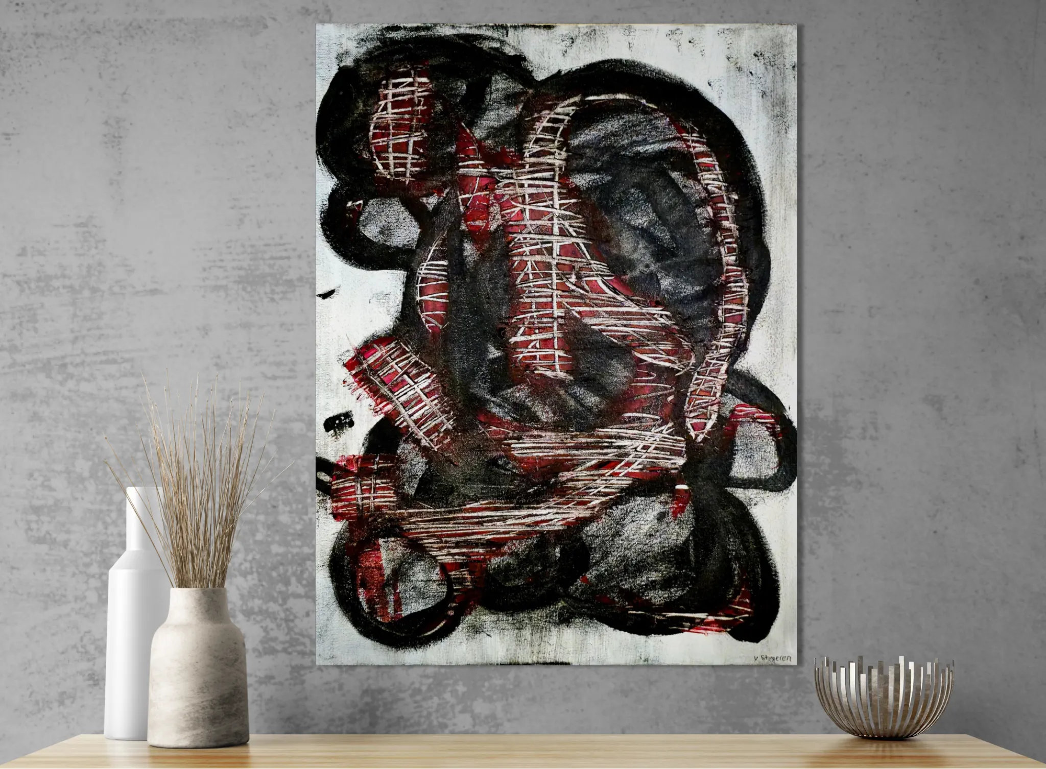 Dark and conceptual abstract portrait in white, black and redposter format displayed in a cabinet with ceramic vases and grey textured wall