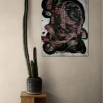 Dark and conceptual abstract portrait in white, black and redposter format displayed in a living space with coffee table and cactus