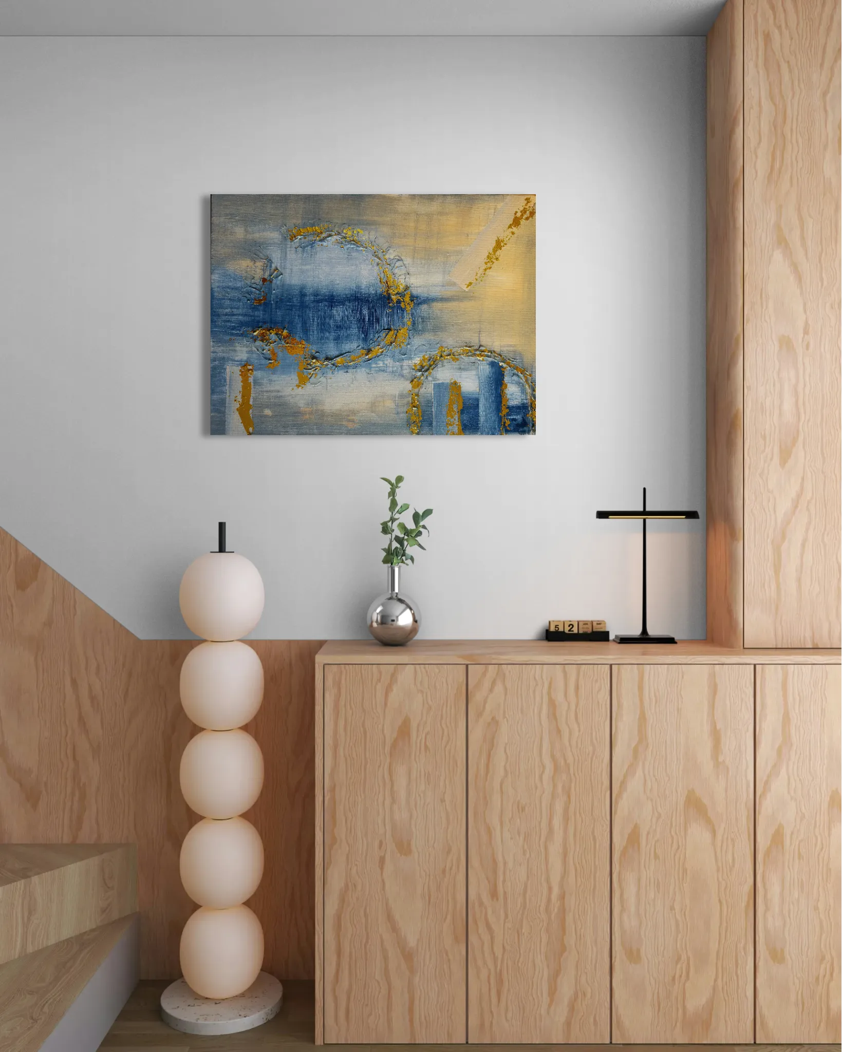 Dreamy glowing abstract landscape in blue and goldposter format displayed in a wooden cabinet next to staircase
