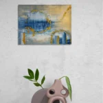 Dreamy glowing abstract landscape in blue and goldoriginal format displayed in a contemporary ceramic vase with white textured wall