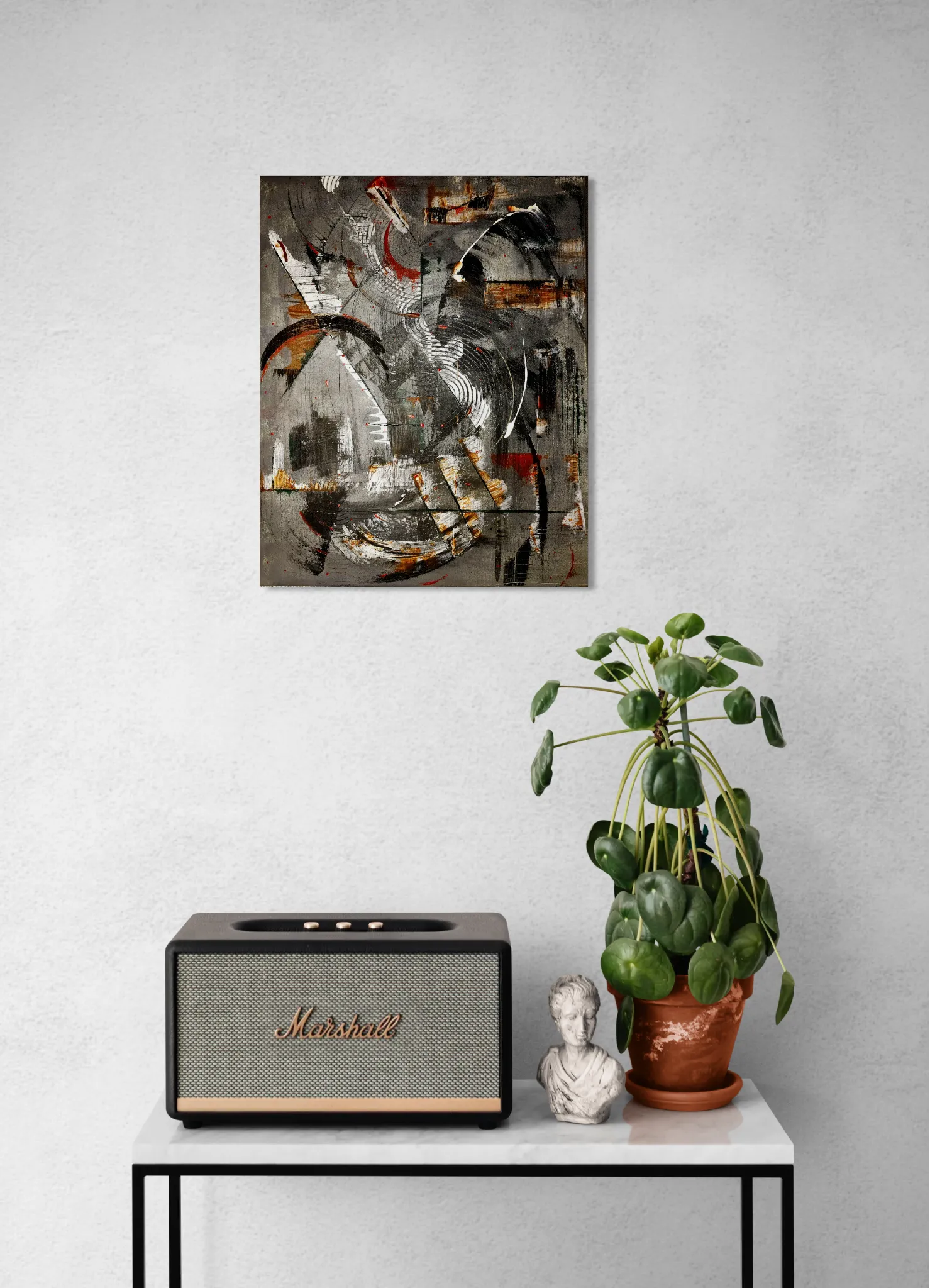 Geometrical, bold and dark abstract portrait in black, grey, white, brown, redoriginal format displayed in a console table with speaker and potted plant