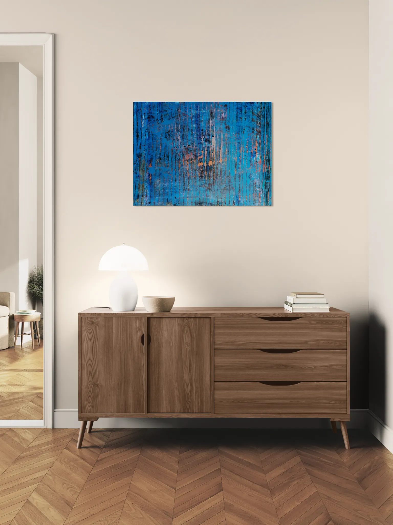 Layered and glowing abstract landscape in orange and blueposter format displayed in a corredor with wooden furniture