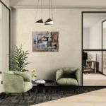 Warm and minimalistic abstract landscape in brown, white and blackoriginal format displayed in a modern living corner with green lounge chairs and window
