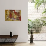 Warm conceptual abstract landscape with mustard yellow, red and brownoriginal format displayed in a modern interior space with glass wall and salon table