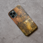 Phone case displayed on a grey concrete surface featuring the artwork “Amsterdam”, an earthy colored abstract artwork.
