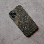 Phone case displayed on a grey concrete surface featuring the artwork “Bangkok”, a textured gold and black abstract piece.