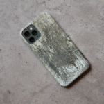 Phone case displayed on a grey concrete surface featuring the artwork “Berlin”, a grey monochromatic abstract piece.