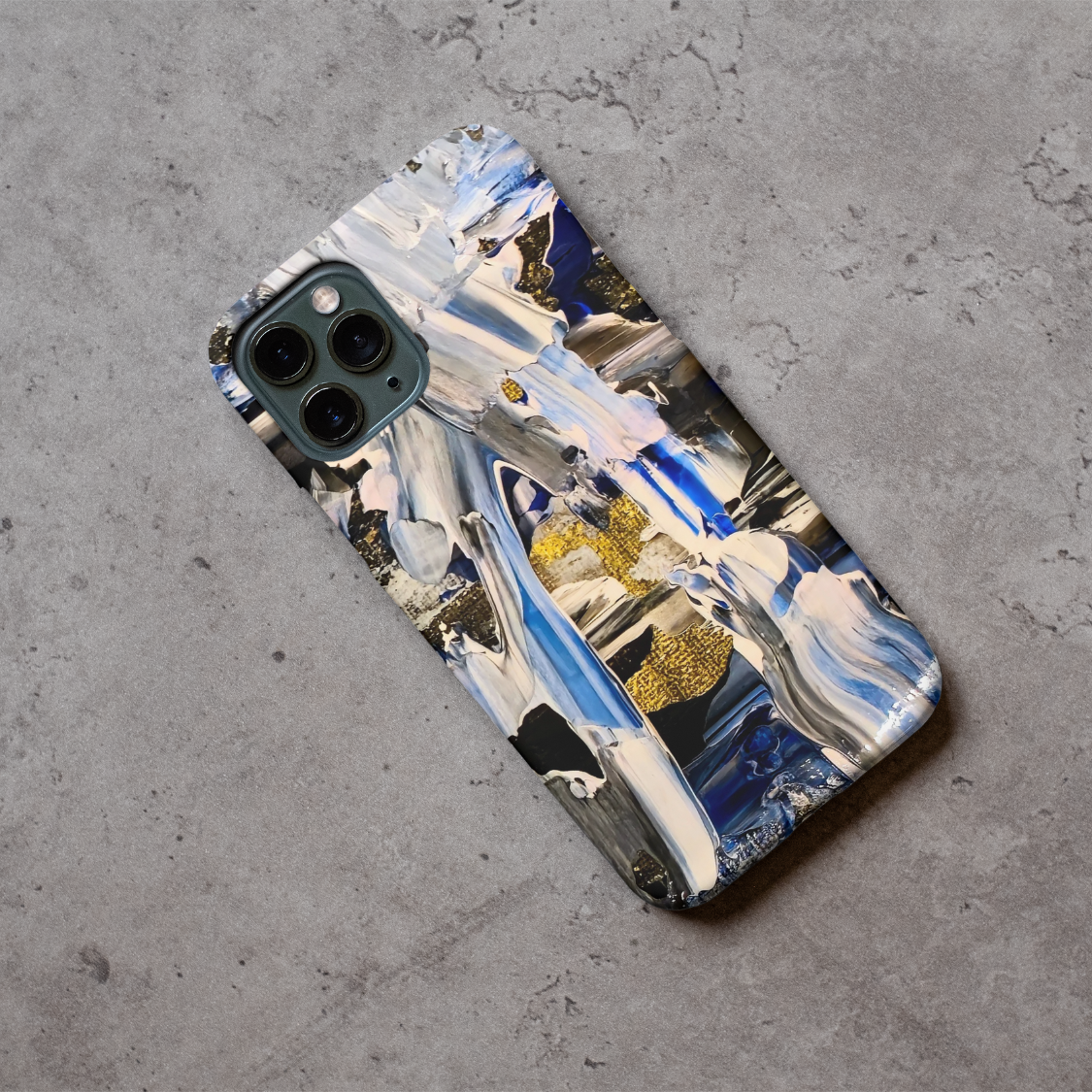 Phone case displayed on a grey concrete surface featuring the artwork “Buenos Aires”, a blue, white, and gold abstract piece.