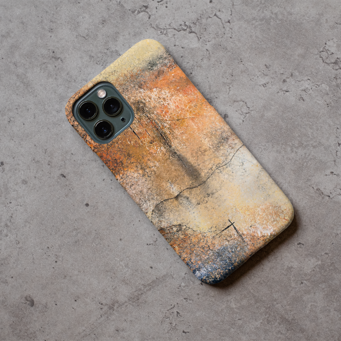 Phone case displayed on a grey concrete surface featuring the artwork “Dusk till Dawn”, an abstract piece with sunset colors.