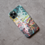 Phone case displayed on a grey concrete surface featuring the artwork “Haarlem”, a colorful, expressive abstract piece.