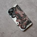 Phone case displayed on a grey concrete surface featuring the artwork “The Quiet Collapse”, a black, white, and red expressive abstract piece.