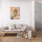 Abstract art poster with hidden face and warm layered colors in a cosy living room