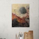 Abstract poster with autumn colors behind artists side table with brushes and palette