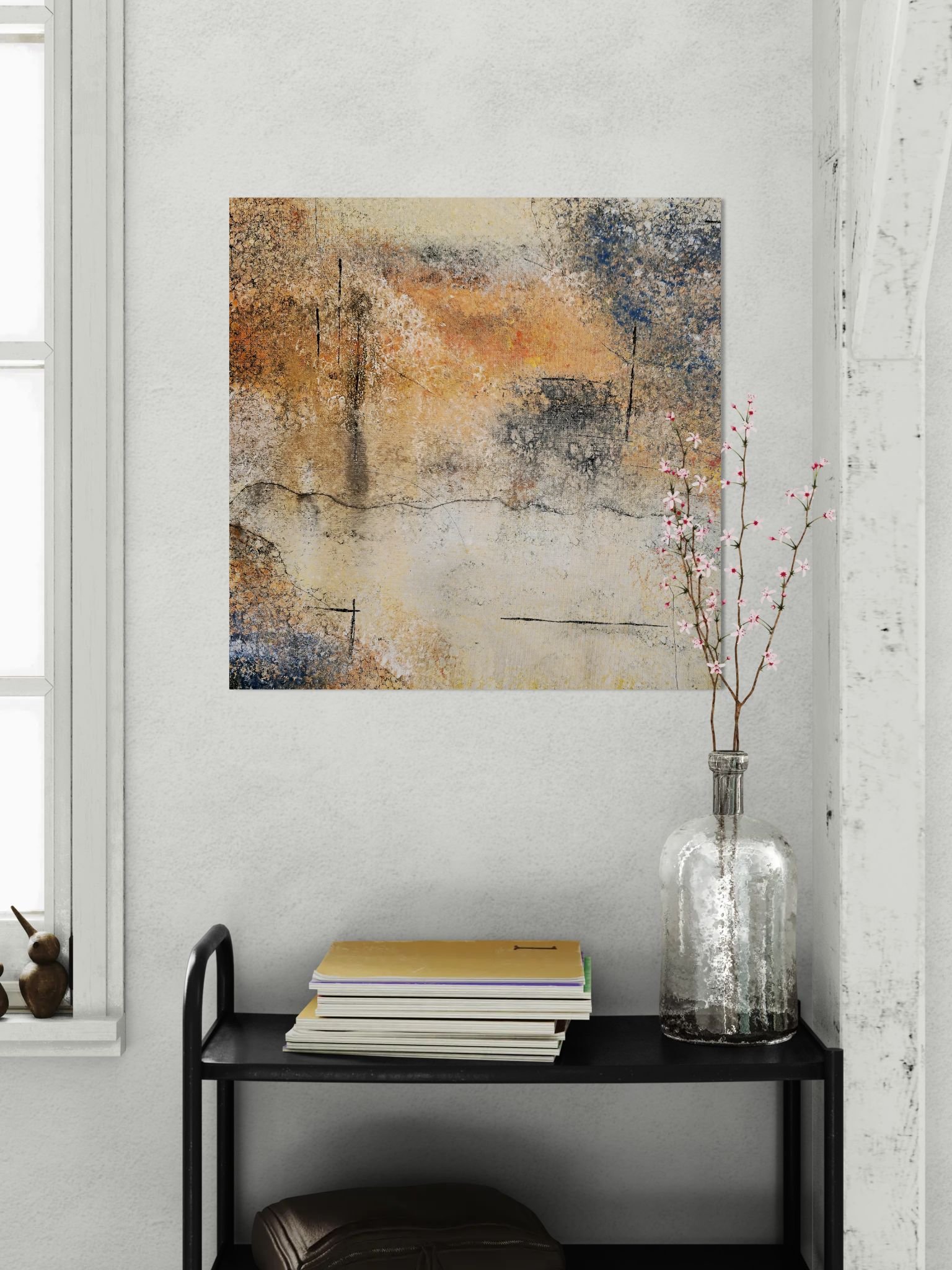 Abstract art poster with sunset warmth, adding bold contrast for modern interior. On grey wall behind trolley with flowers and books
