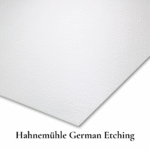 Close-up of Hahnemühle German Etching fine art paper showing its textured, velvety matte surface and warm natural white tone.