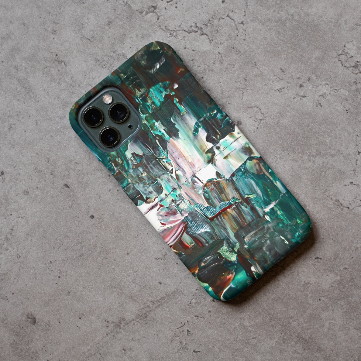 Phone case displayed on a grey concrete surface featuring the artwork “Madrid”, a green and white layered abstract piece.